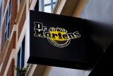 Dr Martens sees profits slide but on track for return to growth