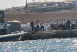 A boat carrying migrants capsizes off Italy, killing at least 26