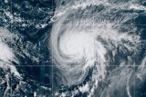Two tropical storm systems near each other could wind up shielding the Carolinas from damage